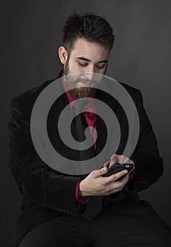 Smiling Man in Formal Attire with Phone