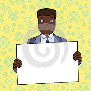 Smiling Man in Formal Suit Holding Big Blank Poster Board in Front of Himself with Both Hands. Creative Background Space photo
