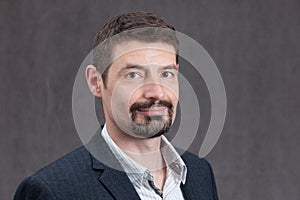 Smiling Man in Forties with a goatee beard and mustache