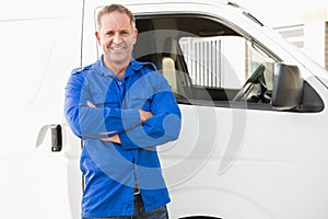 Smiling man in front of delivery van