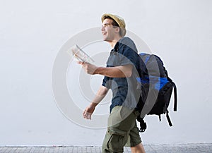 Smiling man going on vacation with bag and map