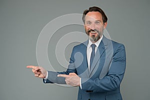 Smiling man good looking businessman pointing copy space, choose direction concept