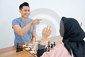 Smiling man with hand pointing at female opponent