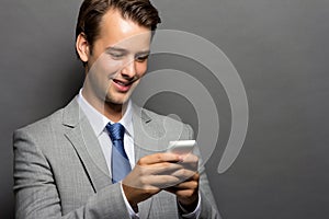 A smiling man with a handphone isolated