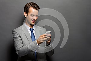 A smiling man with a handphone isolated