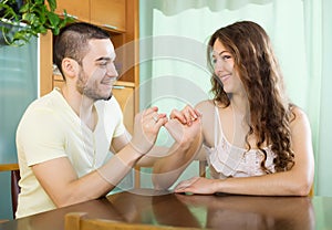 Smiling man and happy woman having conciliation