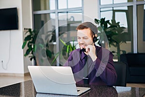 Smiling man with headset working as call center operator