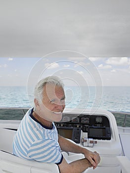Smiling Man At The Helm Of Yacht