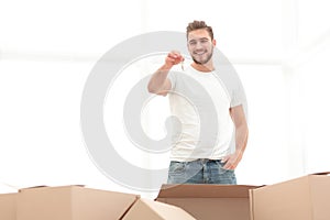 Smiling man holding the keys of new apartments