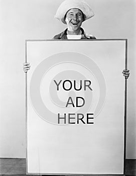 Smiling man holding sign