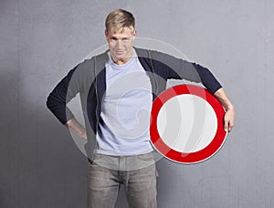 Smiling man holding universal forbidden sign.