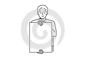 Smiling man holding white mockup poster