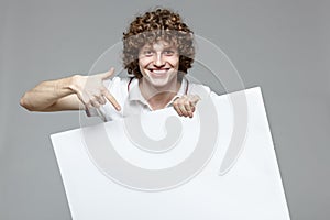 Smiling man holding whiteboard