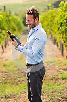 Smiling man holding wine bottle