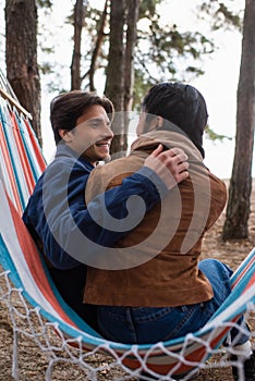 Smiling man hugging asian girlfriend in