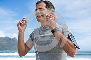 Smiling man listening to music on headphones