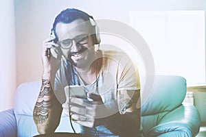 Smiling man listening to music with smart phone