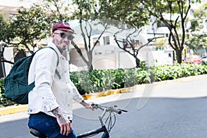 Smiling man looking at camera making a stop on his bike in the city