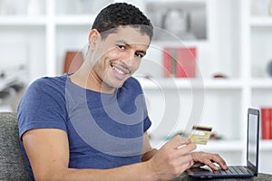 Smiling man making order online