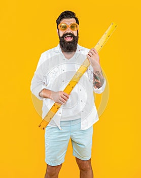 smiling man with measuring ruler isolated on yellow. man with measuring ruler in studio.