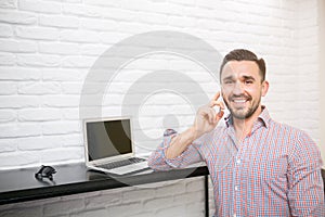 Smiling man during morning phone call