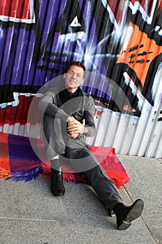 Smiling man near graffiti wall