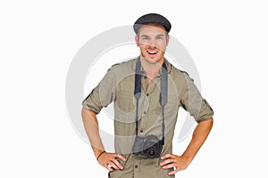 Smiling man in peaked cap with camera around his neck