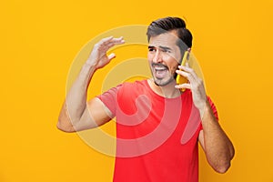 Smiling man phone studio cyberspace communication happy portrait space yellow smartphone copy mobile phone