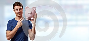 Smiling man with piggy bank.