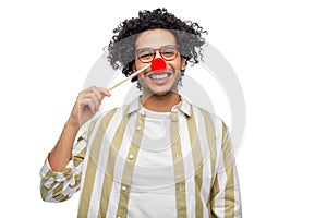 smiling man with red clown nose party accessory