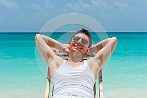 Smiling man relaxing on beach