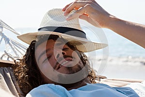 Smiling man relaxing in hammock