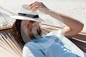 Smiling man relaxing in hammock