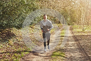Smiling Man Running In Autumn Countryside Exercising During Covid 19 Lockdown