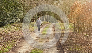 Smiling Man Running In Autumn Countryside Exercising During Covid 19 Lockdown