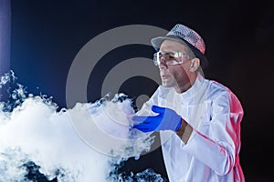 Smiling man scientist with dry ice