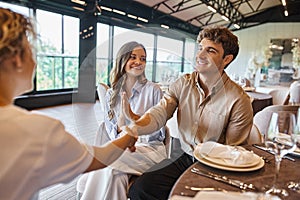 smiling man shaking hands with event