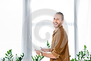 Smiling man in shirt doing paperwork in office