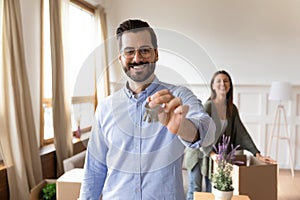 Smiling man show house keys moving in with wife