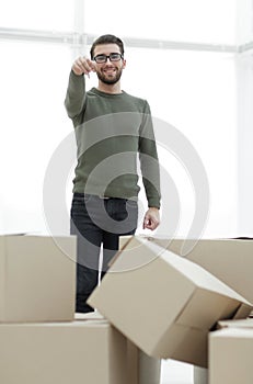 Smiling man showing keys of new apartments