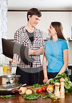 Smiling man shows the new recipe to girl