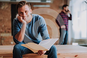 Smiling man is sitting in his workspace