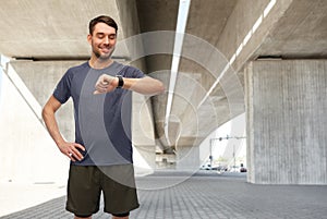 smiling man with smart watch or fitness tracker