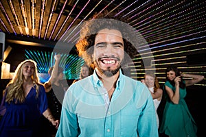 Smiling man standing in dance floor