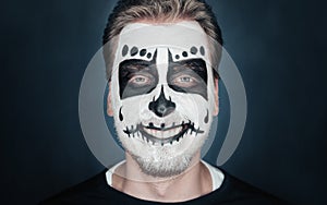 Smiling man with sugar skull makeup