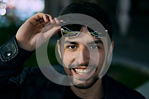 Smiling man in sunglasses with colorful reflection