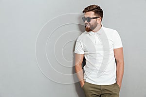 Smiling man in sunglasses posing in studio