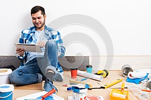 Smiling man surfing internet on tablet computer