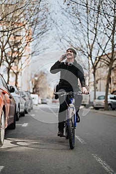 Smiling man talking on phone while riding a bicycle in the city