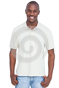 Smiling man with thumbs in pocket